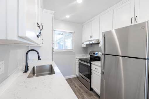 A modern kitchen with a stainless steel refrigerator.