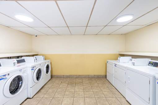 a washer and dryer in a laundry room with washes and washing machines