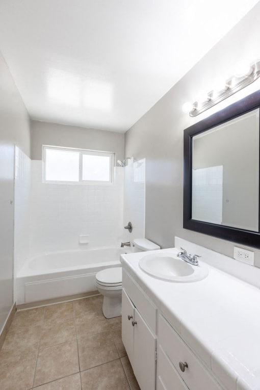 a white bathroom with a sink and a toilet