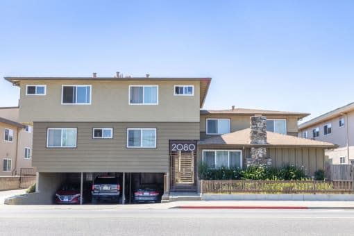 a house with three cars parked in front of it