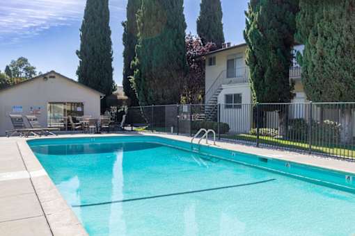 a swimming pool in front of a house