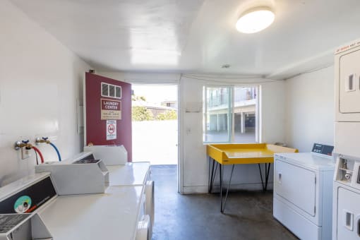 a kitchen with a sink and a yellow table