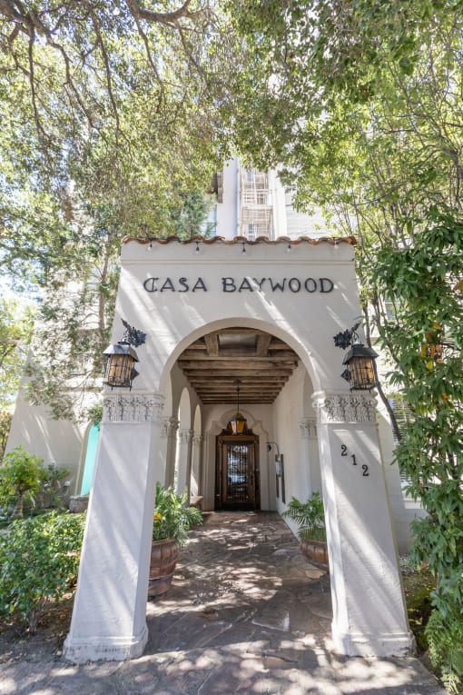 the entrance is a white building with a white archway