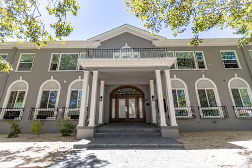 the front of a building with columns and a door
