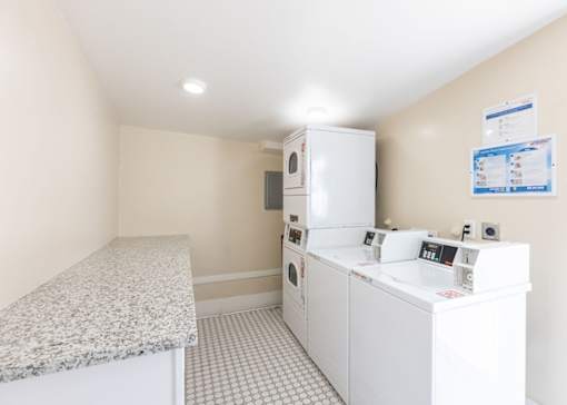 a laundry room with washer and dryer and a counter