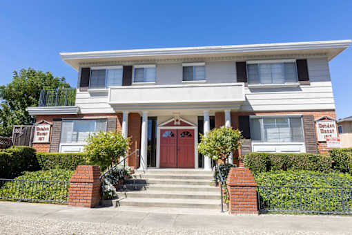 a house with a red door and stairs in front of it