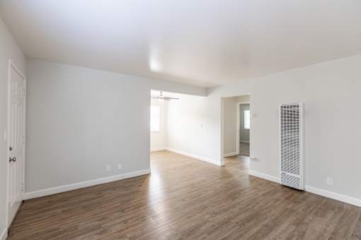 A room with wooden floors and white walls.