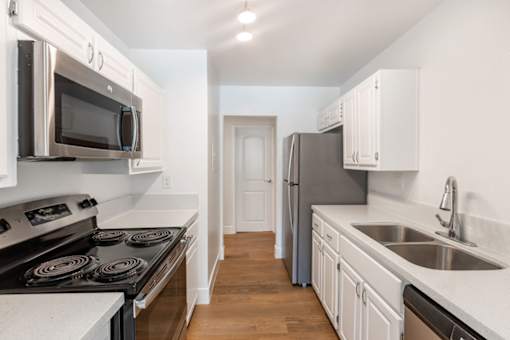a kitchen with stainless steel appliances and white cabinets