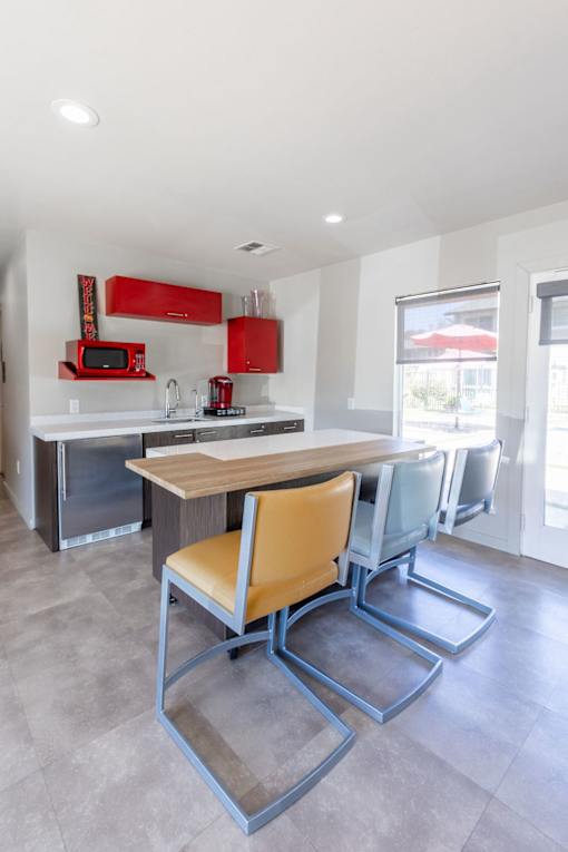 a kitchen with a dining table and chairs