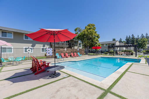 our apartments have a swimming pool with red umbrellas