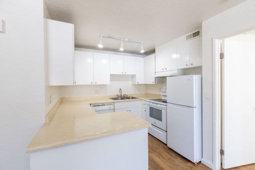 a kitchen with white cabinets and a counter top