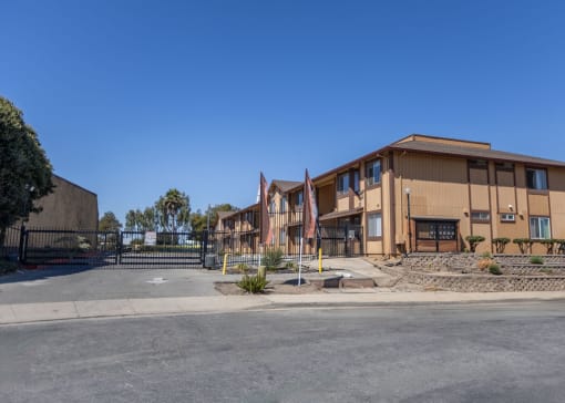 a building with a fence and a street in front of it