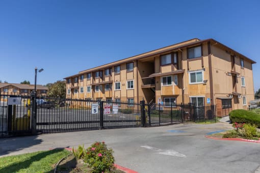 an apartment building with a fence and a gate