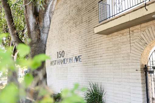 a sign on the side of a brick building