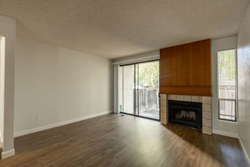 the living room and dining room of an empty house