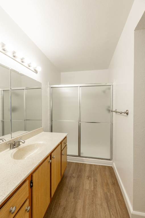a bathroom with a large mirror and a shower