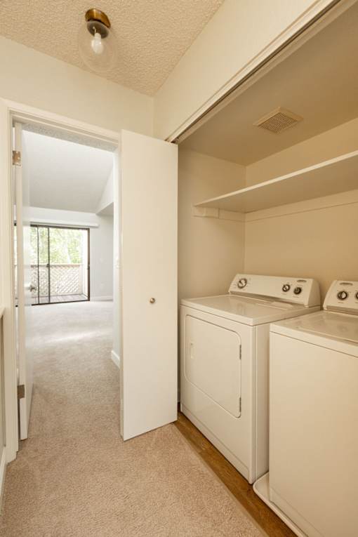 washer and dryer in the laundry room of an empty home