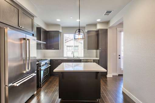 a kitchen with stainless steel appliances and a white counter top