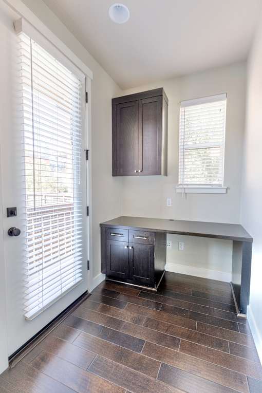 a kitchen with a counter and a dark wood cabinet