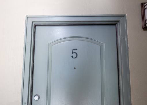 A grey door with the number 5 on it.