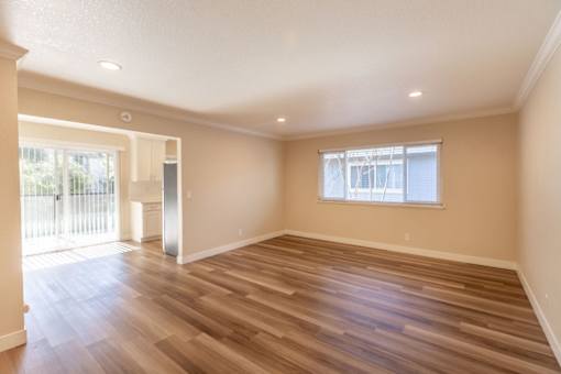 A room with wooden flooring and a window.