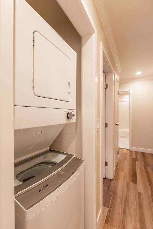 A white dishwasher is built into a kitchen cabinet.