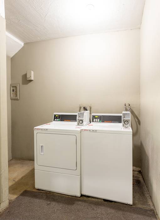 Two identical machines are sitting on the floor.
