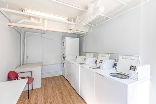 A laundry room with washers and dryers.