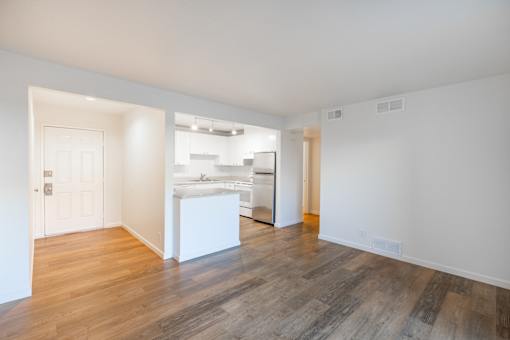 A room with wooden floors and white walls.