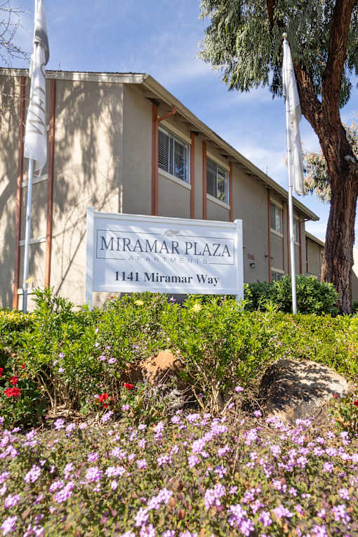 A building with a sign that says Miramar Plaza.