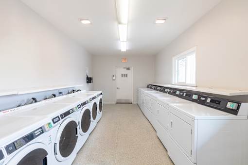 A row of washing machines in a laundromat.