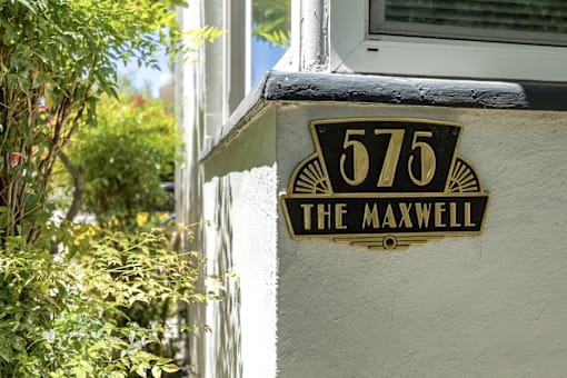 a black and yellow street sign on the side of a building