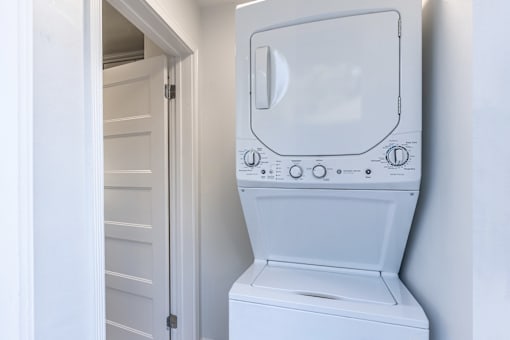 an empty laundry room with a washer and dryer
