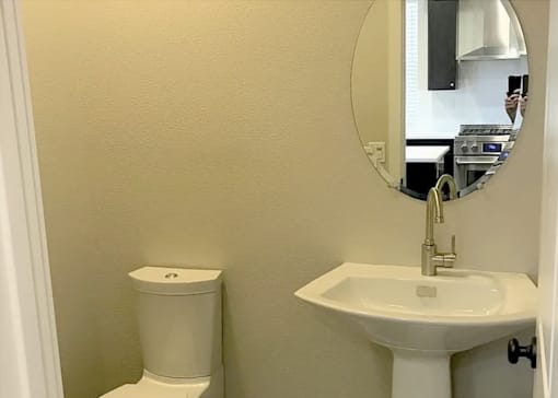 a bathroom with a sink and a mirror and a toilet