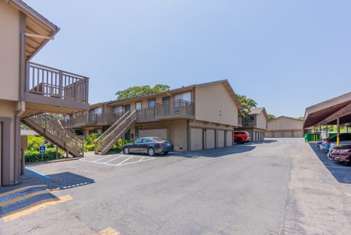 a building with stairs and cars parked in front of it