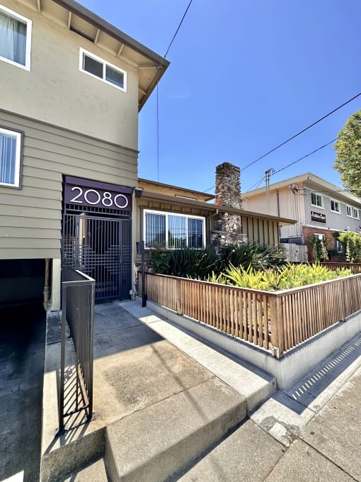 a house with a gate and a sign that reads 2030