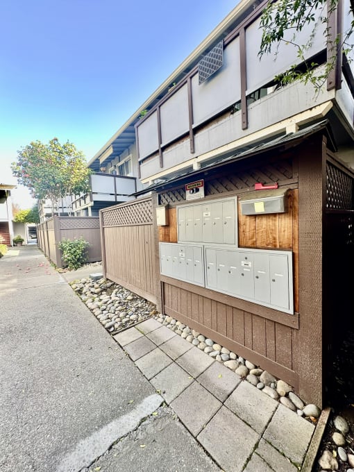 a house with a wooden fence and a sidewalk