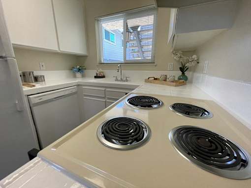 A kitchen with a white stove top oven.