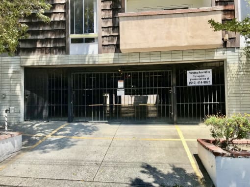 the entrance to a parking garage with a black gate