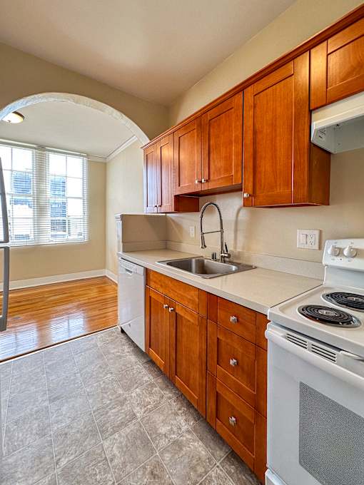 a kitchen with a sink and a stove and a window