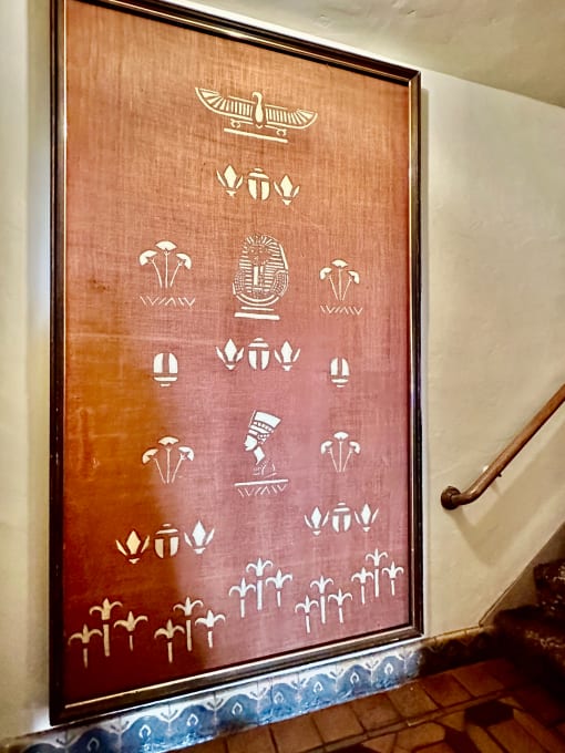a wooden door with symbols on it in a stairwell