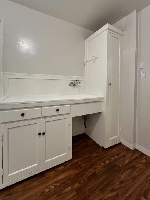 a kitchen with white cabinets and a sink and a counter