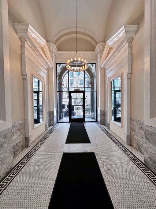 a large hallway with a chandelier and large windows