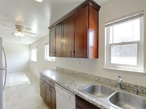 a kitchen with a white refrigerator freezer next to a stove top oven