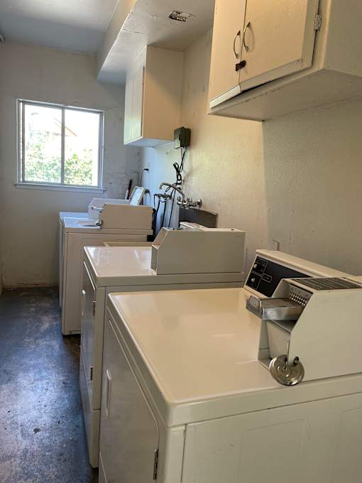 A kitchen with a window and a range hood.