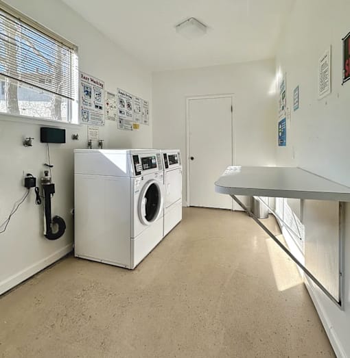 a washer and dryer in a laundry room with other washing machines