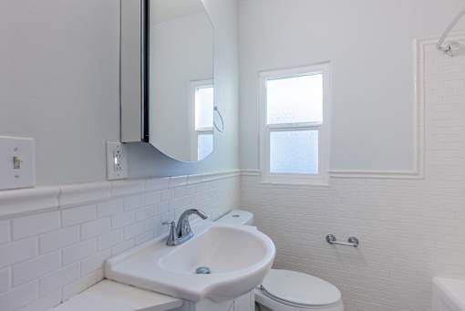 a bathroom with a sink and a mirror and a toilet
