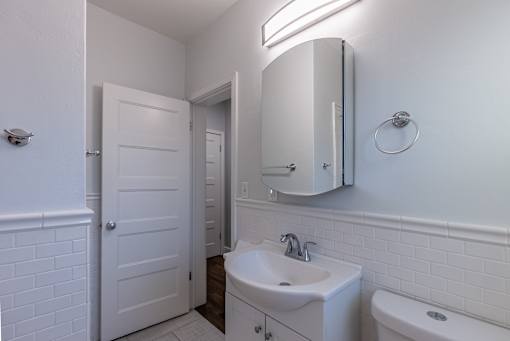 a bathroom with a sink and a mirror and a toilet