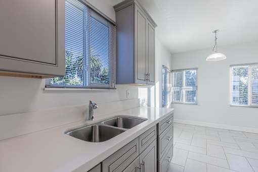 an empty kitchen with a sink and a window