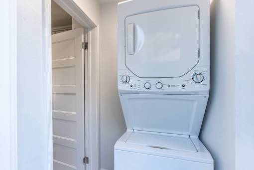 an empty laundry room with a washer and dryer